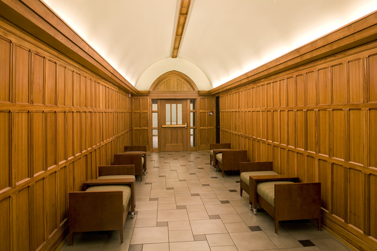 A vaulted, timber-lined circulation gallery in the Vanderbilt Divinity School renovation.
