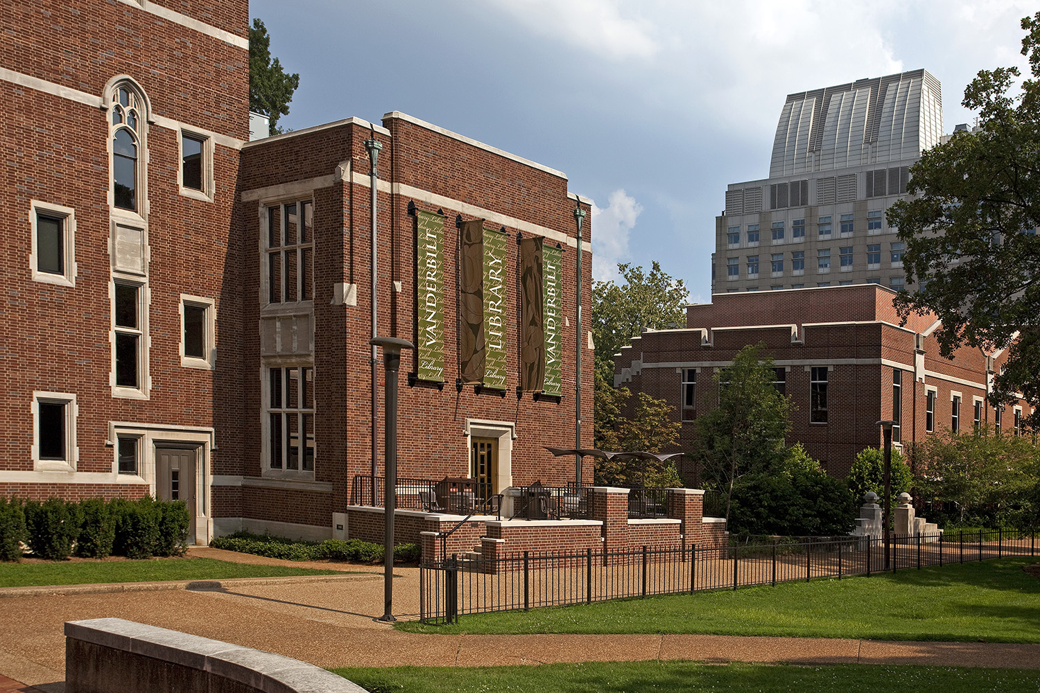 The Jean & Alexander Heard Library at Vanderbilt University, collegiate brickwork with the Nashville skyline behind it.
